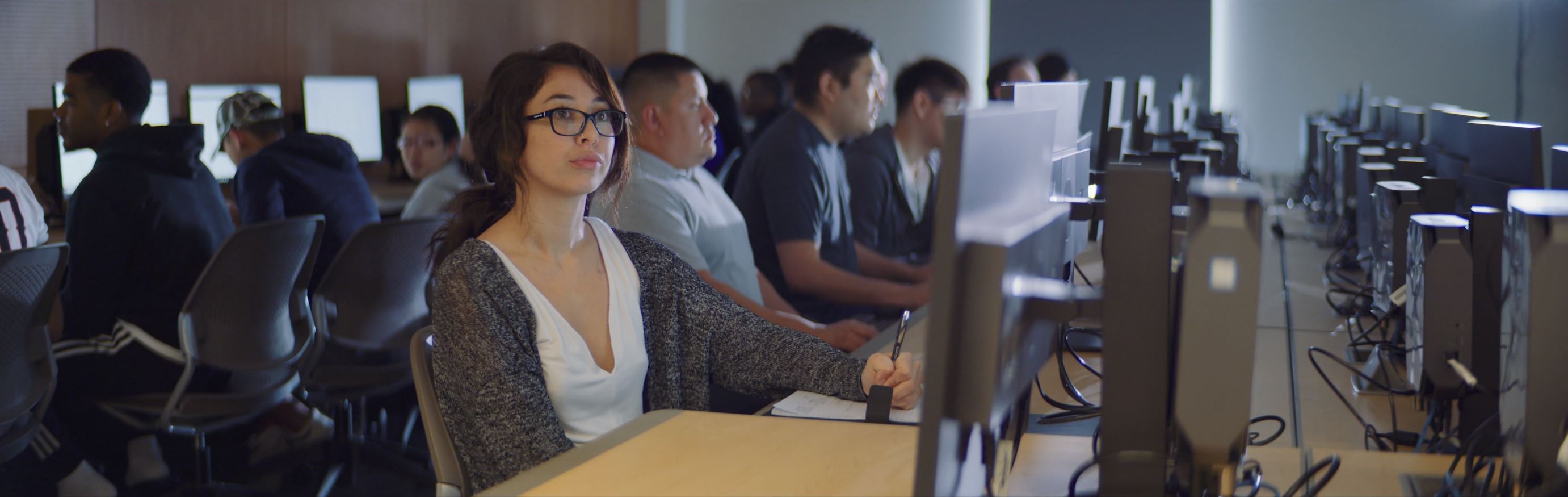 image of students learning in a computer lab.
