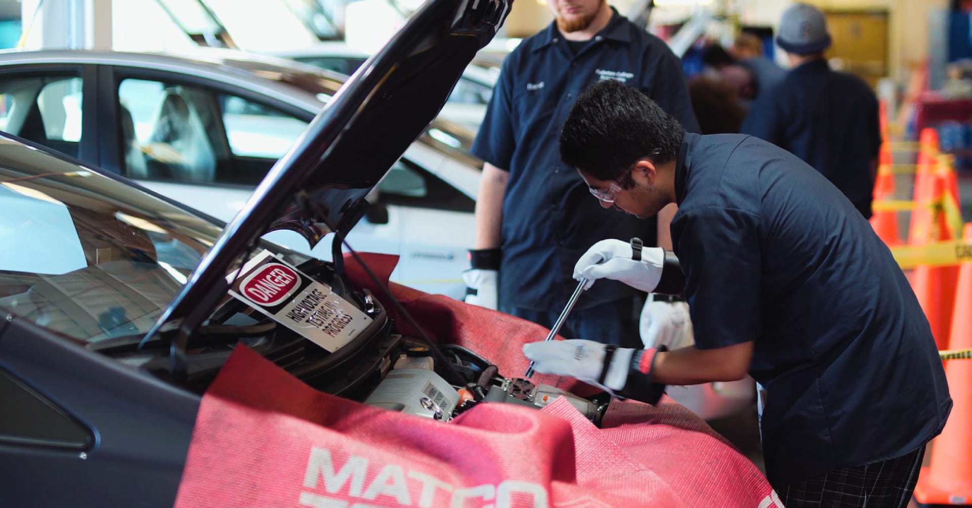 Image showing students working on a car engine